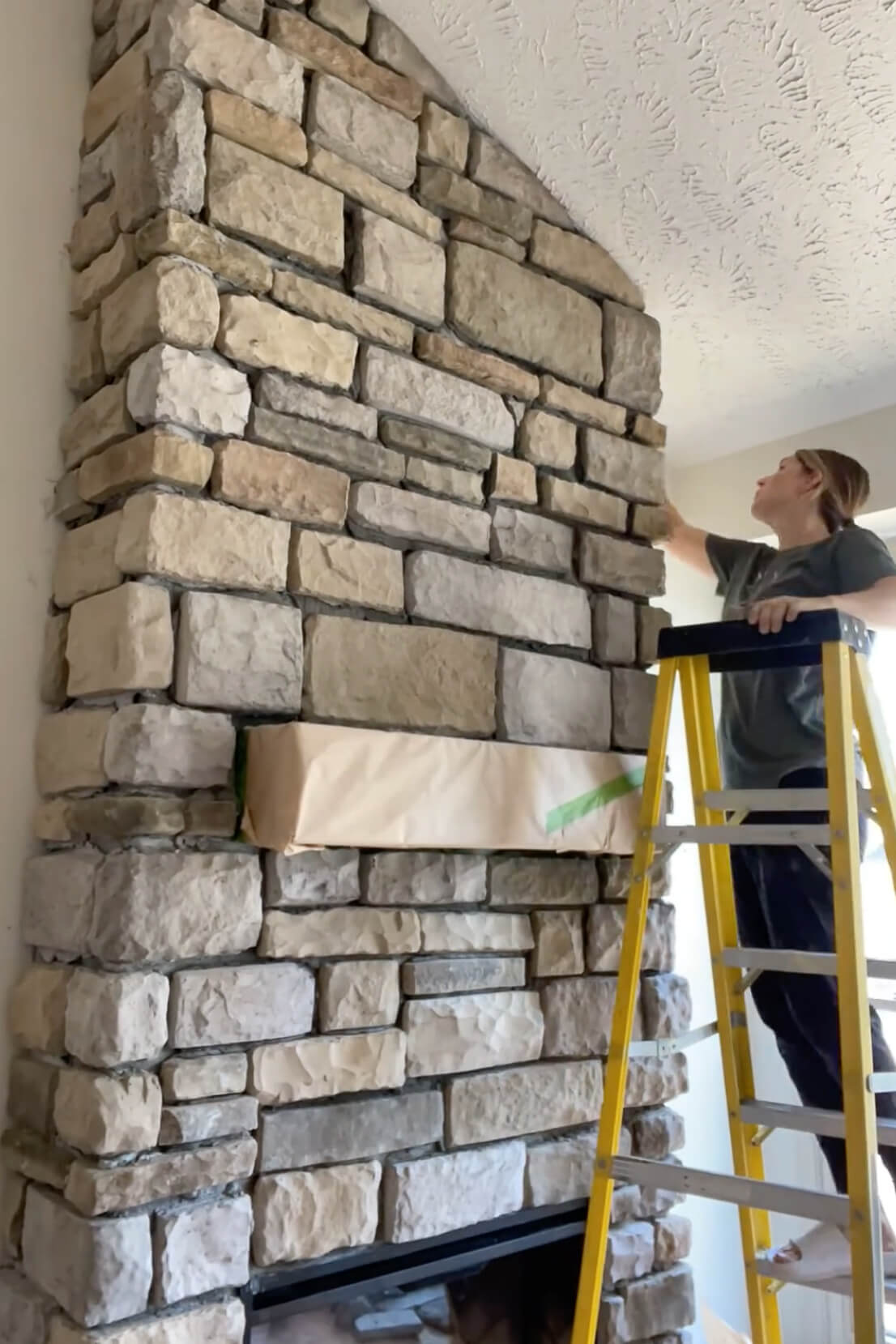 Building a stone fireplace surround.